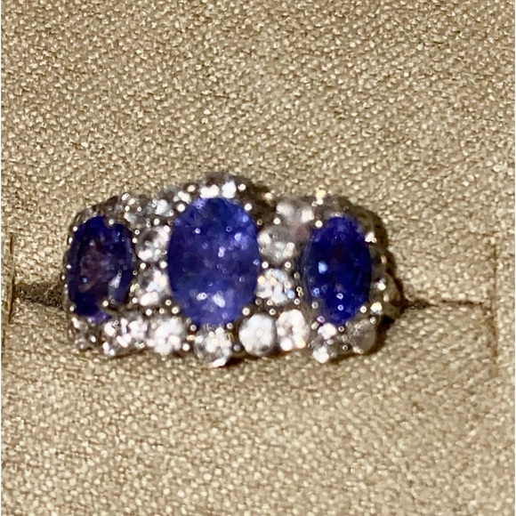 Three stone Tanzanite ring surrounded by pave Zircon...